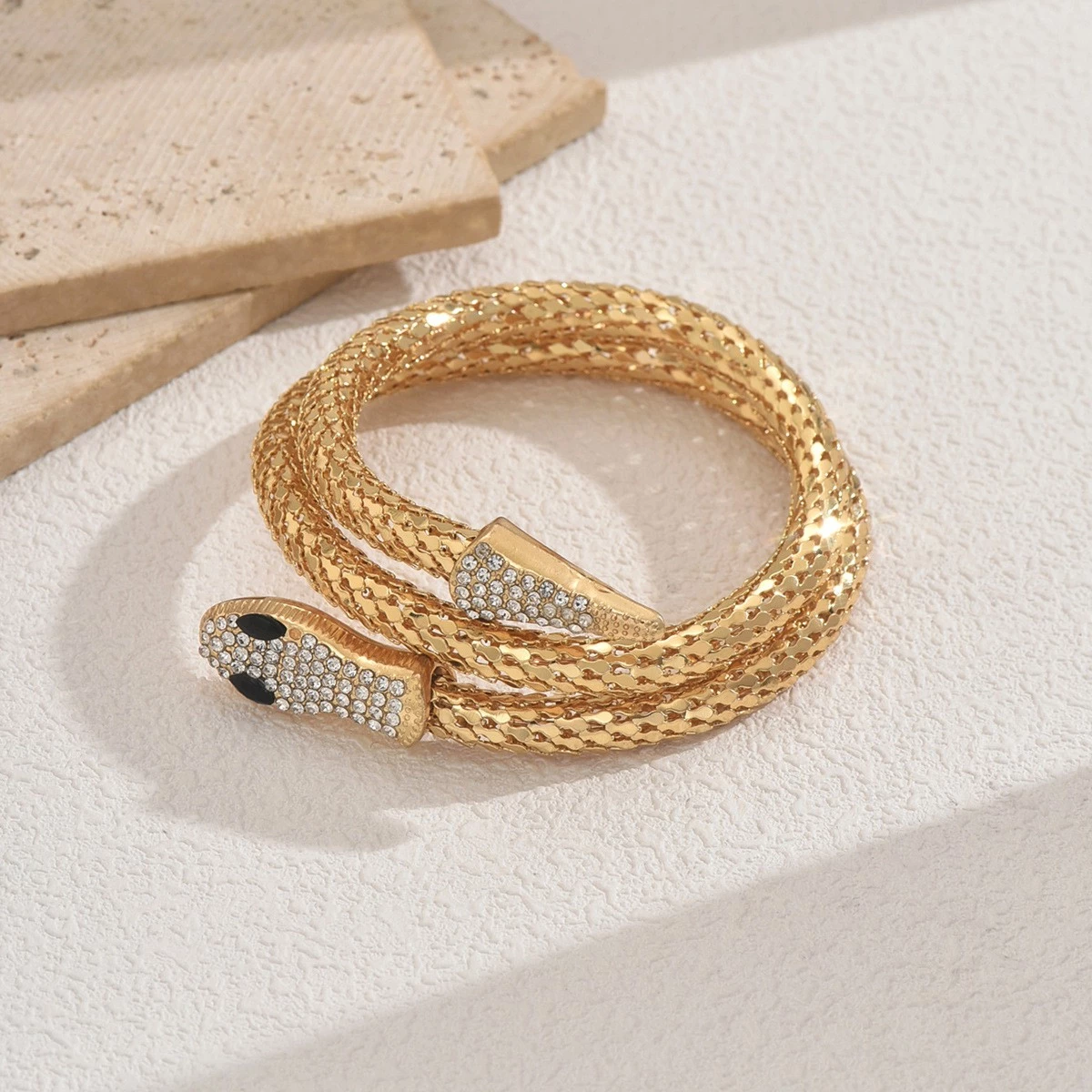 luxury gold snake wrap bracelet with rhinestone detailing luxury gold snake wrap bracelet with rhinestone detailing